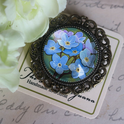 Forget Me Not Ornate Glass Cabochon and Brass Brooch