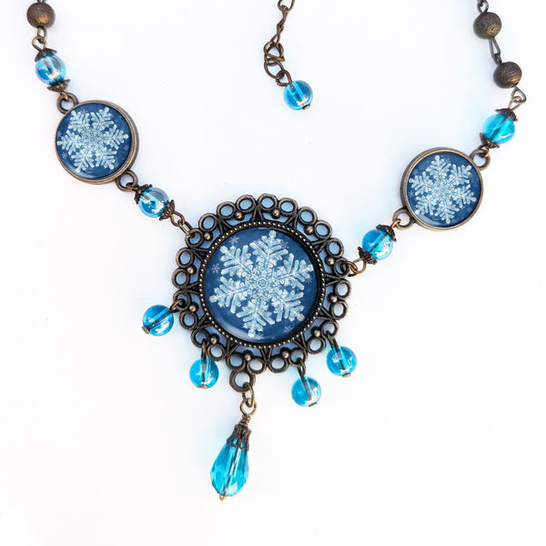 Ornate Snowflake Necklace with Images of Real Snowflakes Decoupaged under Glass in Bronze Filigree